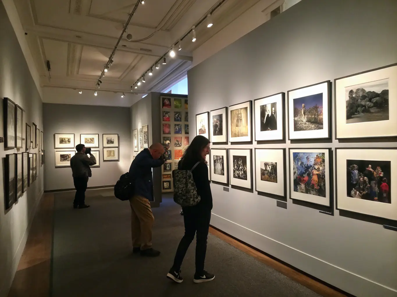 A modern gallery space with film posters, vintage cameras, and archival documents on display, ideal for an exhibition event.